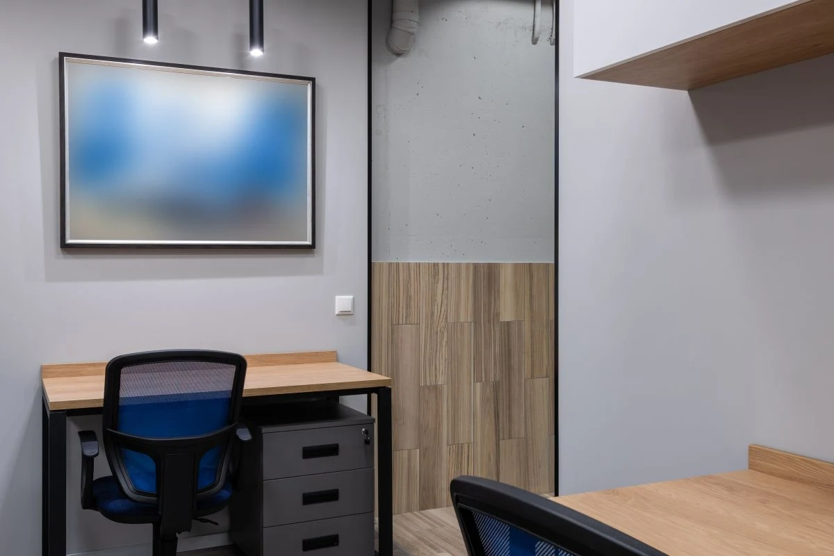 Stock photograph of a clean contemporary office with wood desks and blue chairs